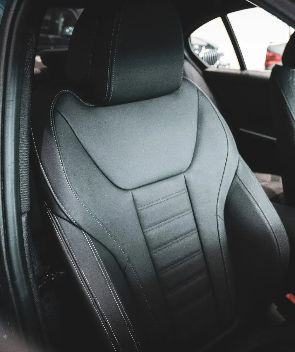 Black leather front seat with grey contrast stitching, cleaned and conditioned